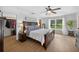 Bright bedroom with wood flooring and a large window that provides natural light and a view of the outdoors at 6875 Myakka Valley Trl, Sarasota, FL 34241