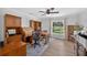Bright office space with wood furnishings and a large window showcasing the lawn at 6875 Myakka Valley Trl, Sarasota, FL 34241