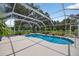 Stunning screened-in pool and spa area surrounded by lush greenery at 6875 Myakka Valley Trl, Sarasota, FL 34241