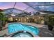 An enclosed backyard pool with a connected hot tub surrounded by lush plants and comfortable outdoor furniture at 6875 Myakka Valley Trl, Sarasota, FL 34241