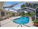 Inviting pool area with a screened enclosure and scenic views of the surrounding landscape at 6875 Myakka Valley Trl, Sarasota, FL 34241