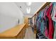 Large walk-in closet with custom shelving, hanging racks, drawers, and dressing area at 6875 Myakka Valley Trl, Sarasota, FL 34241
