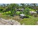 Aerial shot of the backyard featuring mature trees, a chicken coop, and fencing at 6875 Myakka Valley Trl, Sarasota, FL 34241