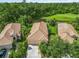 Aerial view of homes with tile roofs, mature landscaping, and paver driveways at 7343 Birds Eye Ter, Bradenton, FL 34203