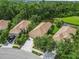 Aerial view of homes with tile roofs and mature landscaping at 7343 Birds Eye Ter, Bradenton, FL 34203