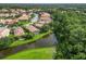 Aerial view of homes with tile roofs that sit on the pond at 7343 Birds Eye Ter, Bradenton, FL 34203
