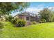 Expansive backyard showcasing a covered patio and beautifully landscaped grounds, perfect for outdoor enjoyment at 7343 Birds Eye Ter, Bradenton, FL 34203