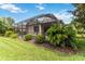 Spacious backyard features a covered patio, manicured lawn, and lush landscaping at 7343 Birds Eye Ter, Bradenton, FL 34203