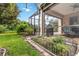 Lush backyard featuring a well-maintained lawn and covered patio perfect for relaxing and dining at 7343 Birds Eye Ter, Bradenton, FL 34203