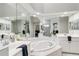 Bright primary bathroom with a large garden tub, a separate shower, and dual vanities at 7343 Birds Eye Ter, Bradenton, FL 34203