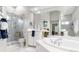 Bright bathroom features a spacious shower with glass doors, and a large garden tub at 7343 Birds Eye Ter, Bradenton, FL 34203