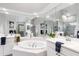 Bright primary bathroom with a large garden tub, a separate shower, and dual vanities at 7343 Birds Eye Ter, Bradenton, FL 34203