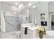 Bright bathroom features a spacious shower with glass doors, and a large vanity with an integrated sink at 7343 Birds Eye Ter, Bradenton, FL 34203