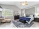 Relaxing bedroom with a vaulted ceiling, plantation shutters, and a cozy sitting area at 7343 Birds Eye Ter, Bradenton, FL 34203
