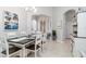 Well-lit dining room with white trim and light-colored walls, leading to multiple rooms and hallway at 7343 Birds Eye Ter, Bradenton, FL 34203
