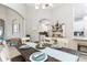 Bright dining room with a dark wood table, white chairs, and an open layout to the kitchen at 7343 Birds Eye Ter, Bradenton, FL 34203
