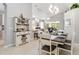 Elegant dining room featuring a modern chandelier, and an open floor plan leading to the living space at 7343 Birds Eye Ter, Bradenton, FL 34203