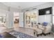 Inviting living room with serene backyard views, plantation shutters, and a view of the eat-in kitchen at 7343 Birds Eye Ter, Bradenton, FL 34203