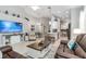 Spacious living room with high ceilings, an open layout, tile floors, and a view into the kitchen at 7343 Birds Eye Ter, Bradenton, FL 34203