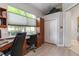 Bright home office featuring a large window overlooking the landscaped yard and built-in shelves at 7343 Birds Eye Ter, Bradenton, FL 34203