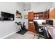Well-lit home office featuring built-in wooden cabinets and a modern exercise bike setup at 7343 Birds Eye Ter, Bradenton, FL 34203