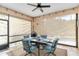 Inviting screened patio featuring dining set, ceiling fan, and seamless transition to outdoor living at 7343 Birds Eye Ter, Bradenton, FL 34203