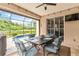 Charming patio featuring a dining set and an amazing view of the lake and swimming pool at 7343 Birds Eye Ter, Bradenton, FL 34203