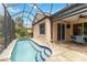 Screened-in pool area with a refreshing pool, tile patio, and outdoor dining space, perfect for relaxation at 7343 Birds Eye Ter, Bradenton, FL 34203