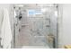 Modern glass shower with tiled walls, built-in shelving, and accessible grab bars at 7343 Birds Eye Ter, Bradenton, FL 34203