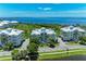 Aerial view of residences with waterfront views and community landscaping and palm trees at 7820 34Th W Ave # 102, Bradenton, FL 34209