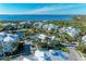 Aerial view of the residences with water views, pool, landscaping, and palm trees at 7820 34Th W Ave # 102, Bradenton, FL 34209