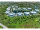 Aerial view of residences surrounding a lake with palm trees in a neighborhood community at 7820 34Th W Ave # 102, Bradenton, FL 34209