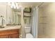 Well-lit bathroom with granite countertop, wood vanity, and tiled walk-in shower at 7820 34Th W Ave # 102, Bradenton, FL 34209