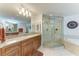 Modern bathroom with granite counters, glass-enclosed shower, and separate tub features a luxurious spa-like experience at 7820 34Th W Ave # 102, Bradenton, FL 34209