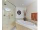 Stylish bathroom featuring a glass shower, soaking tub, and granite countertop creates a spa-like atmosphere at 7820 34Th W Ave # 102, Bradenton, FL 34209