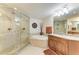 Elegant bathroom with a glass-enclosed shower, soaking tub, granite vanity, and modern fixtures exudes luxury at 7820 34Th W Ave # 102, Bradenton, FL 34209