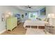 Well-lit bedroom with a ceiling fan, window, television, and an ensuite bathroom entrance at 7820 34Th W Ave # 102, Bradenton, FL 34209