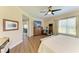 Bedroom with ceiling fan, wood floors, a sitting area, and access to living areas at 7820 34Th W Ave # 102, Bradenton, FL 34209