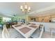 Dining area with large windows, chandelier, and open access to the kitchen and living room at 7820 34Th W Ave # 102, Bradenton, FL 34209