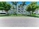 A well maintained condo building with a charming exterior, featuring a central staircase and lush landscaping at 7820 34Th W Ave # 102, Bradenton, FL 34209