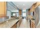 Modern kitchen with granite countertops, wood cabinets, stainless steel appliances, and barstool seating at 7820 34Th W Ave # 102, Bradenton, FL 34209