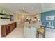 A spacious condo kitchen with granite countertops, bar stool seating, a wine rack, and tiled flooring at 7820 34Th W Ave # 102, Bradenton, FL 34209