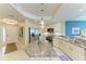 Well-lit open kitchen with stainless steel appliances, granite counters, an island, and tiled flooring at 7820 34Th W Ave # 102, Bradenton, FL 34209