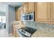 This kitchen features sleek stainless steel appliances, granite countertops, and ample wood cabinet storage at 7820 34Th W Ave # 102, Bradenton, FL 34209