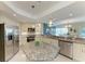 Kitchen with stainless steel appliances, granite countertops, island and bar area with pendant lighting at 7820 34Th W Ave # 102, Bradenton, FL 34209