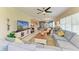 Open concept living room with comfortable seating, large TV, and seamless flow to the kitchen and dining areas at 7820 34Th W Ave # 102, Bradenton, FL 34209