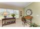 Well-lit office with a window view, decorative clock, and wooden drafting table provides a serene and functional workspace at 7820 34Th W Ave # 102, Bradenton, FL 34209