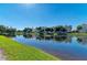 Scenic view of pond surrounded by community buildings and lush trees at 7820 34Th W Ave # 102, Bradenton, FL 34209