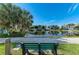 Relaxing pond view featuring mature trees and nearby community buildings at 7820 34Th W Ave # 102, Bradenton, FL 34209