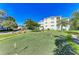 Community putting green surrounded by tropical landscape at 7820 34Th W Ave # 102, Bradenton, FL 34209
